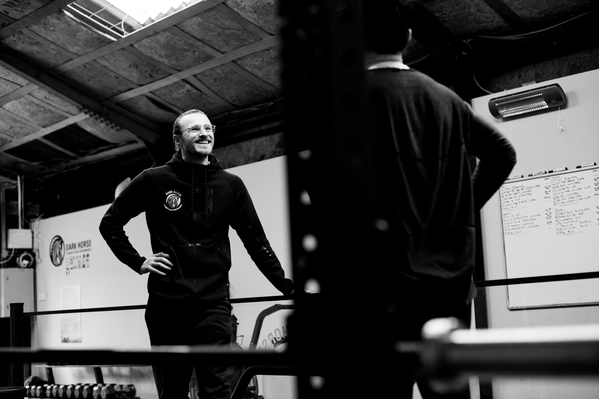 Conor McCarthy, Dark Horse owner and coach, mid-conversation in the gym.