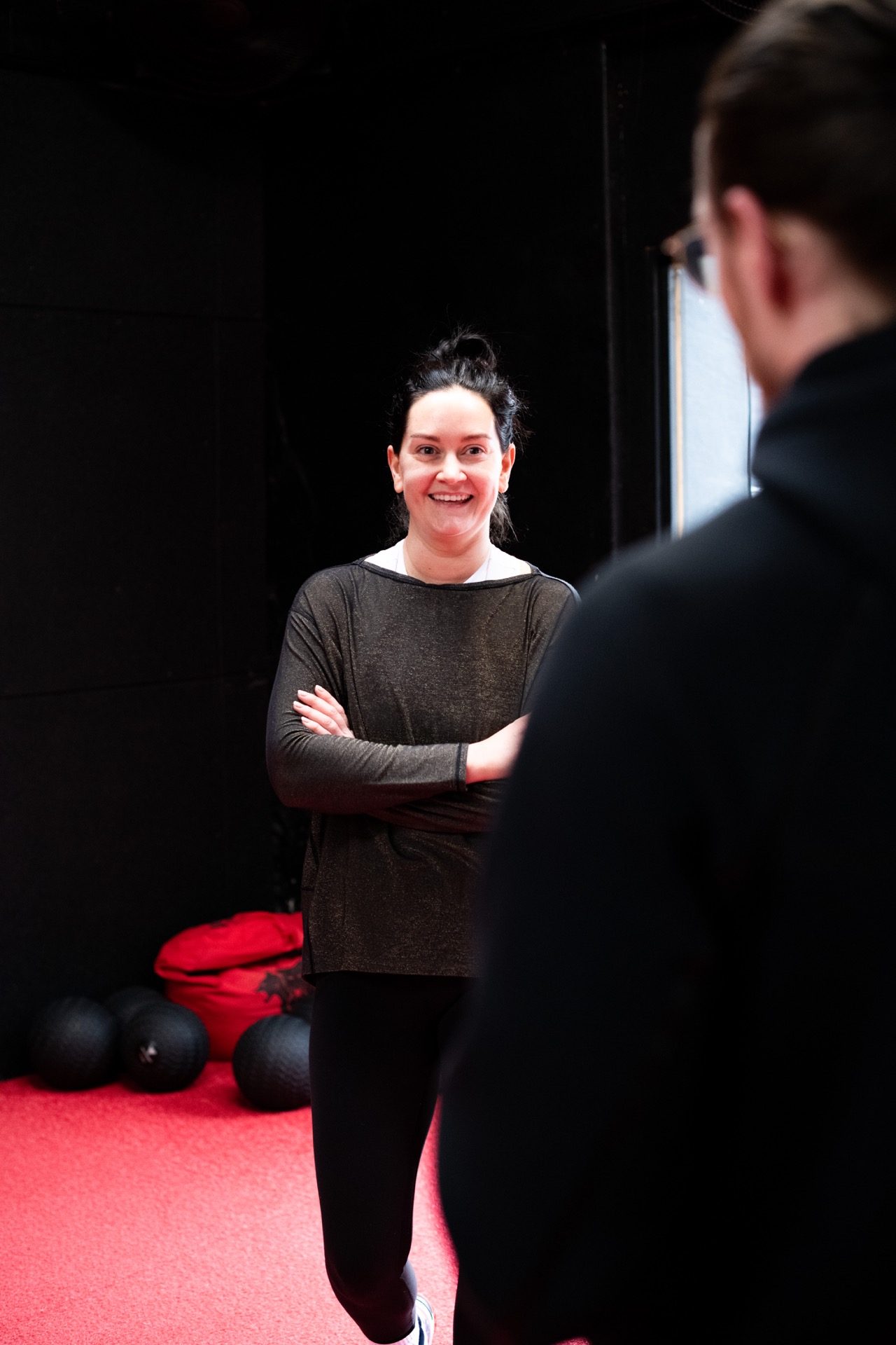 A member smiling mid-conversation with a Dark Horse coach.