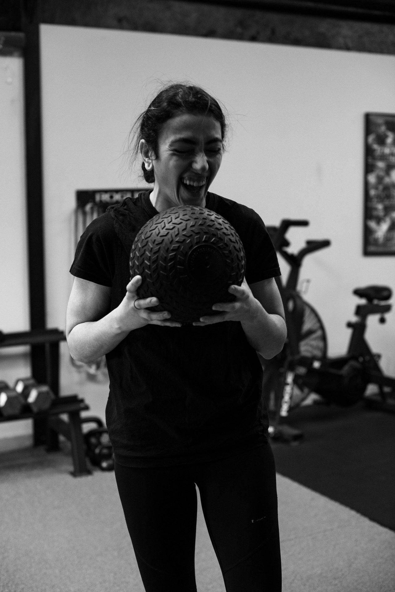 A Dark Horse member mid-session, smiling with a slam ball.